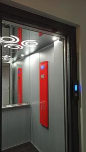a wall with two red boxes on the wall at Bella Luxury Suite II in Paralia Katerinis