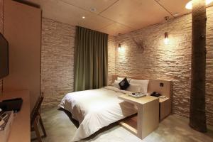 En eller flere senger på et rom på Hotel Cullinan Geondae 1