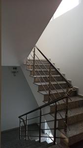 a staircase in a house with a metal railing at Bella Luxury Suite II in Paralia Katerinis +1 photo