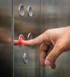 a hand is pressing a door knob on a shower at Aloha Hotel Quy Nhơn in Quy Nhon +36 photos