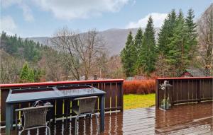 a deck with two chairs and a bar on a rainy day at 2 Bedroom Awesome Home In Moi in Moi