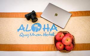 a birthday cake with a laptop and a bowl of apples at Aloha Hotel Quy Nhơn in Quy Nhon