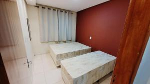 a small room with two beds in it at Apartamento Aparecida Rone 2 in Aparecida