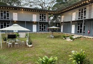 a building with tables and umbrellas in a yard at 1108 Carebin Slim River in Slim River