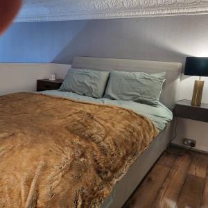 uma cama com um cobertor num quarto em 5 Luxury Spacious Loft - Prime Location - Comfortable Bed & Sofa em Brighton & Hove