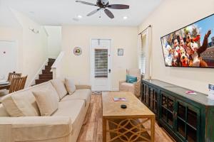 a living room with a couch and a flat screen tv at 3000 Latitude Lane in Orlando