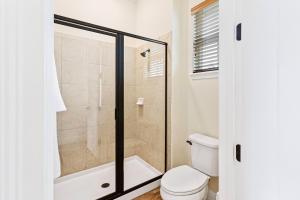 a bathroom with a shower and a toilet at 3000 Latitude Lane in Orlando +36 photos