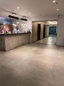 a man standing at a counter in a lobby at Fully furnished condo in Quezon City in Manila +18 photos