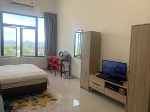 a bedroom with a bed and a flat screen tv at David Studio Unicity, Seremban 3 in Seremban +37 photos