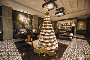 a christmas tree in the lobby of a store at The Odys Boutique Hotel in Ho Chi Minh City