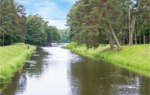 a river with a person walking on it at Beautiful Home In Krzynia With Wifi in Krzynia