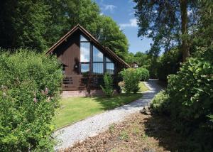 a house with a pathway leading to it at Exmoor Gate Lodges in Chipstable