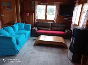 uma sala de estar com um sofá e uma mesa de centro em Chalet Familial en Bois à 150 m de la Mer em Santec