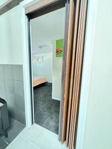 a bathroom with a shower with a glass door at CandE’s Guesthouse in Kingscote