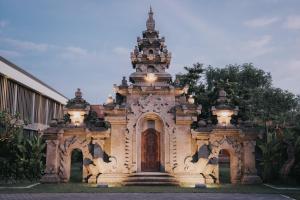 an ornate building with lights on top of it at Anja Jimbaran in Jimbaran