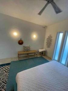 a bedroom with a bed and a bench in it at Luxury 1 Bedroom Beach House Casa Dos Aguas in Yelapa