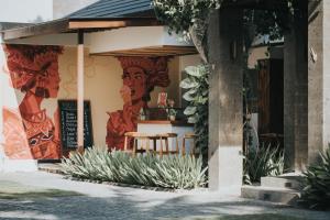 a restaurant with a mural on the side of a building at Anja Jimbaran in Jimbaran