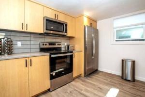 a kitchen with a stove and a refrigerator at North End Bungalows Downstairs in Boise
