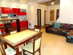 a kitchen and living room with a table and a couch at Real Home Apartments in Kiev Center in Kyiv