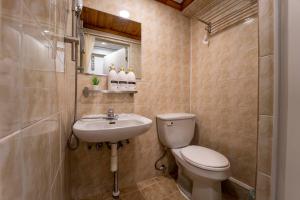 a bathroom with a toilet and a sink at Seoul Mansion Guesthouse in Seoul