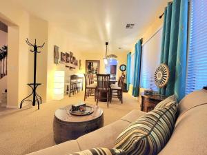 a living room with a couch and a table at 5 Bedroom House with Pool in Casa Grande