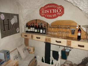 a bar with bottles of wine on a wall at La Loggia Di Federico in Navelli