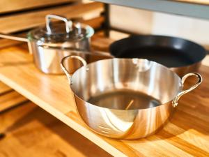 a metal bowl on a counter with two pans at Rakuten STAY HOUSE x WILL STYLE Saga Imari 101 in Imari