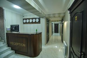 a hallway with a reception desk in a building at BRICK PALACE in Samarkand