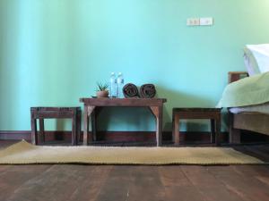 a living room with a table and two chairs at Navareeya House Seaview in Ko Lanta