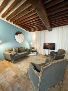 a living room with two couches and a tv at L ORANGER - Plein centre - 6 Personnes - Clim in Cassis