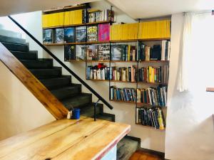 a staircase with bookshelves and a wooden table at Stay at Bokkoms in Paternoster Self Catering Accommodation in Paternoster
