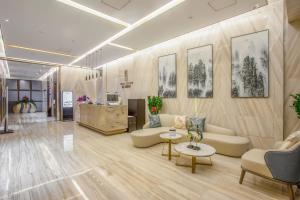 a lobby with couches and tables in a building at Shenzhen Kingkey Kingyu Hotel in Shenzhen