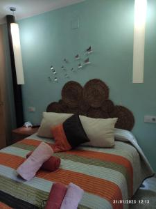 a bedroom with a large bed with pillows on it at Tu rincon favorito. in Olvera