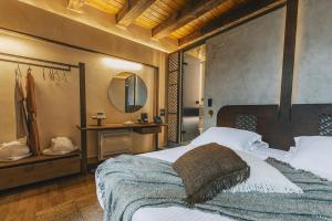 Un dormitorio con una cama grande y un espejo. en Oniros Residenza Vecchia, en La Canea