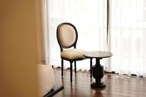 a chair and a table in front of a window at Lalita Tam Coc Resort & Spa in Ninh Binh +84 photos