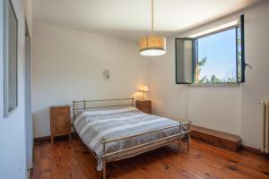 een slaapkamer met een bed en een raam bij Dimora Pietre Verdi in Cosentino