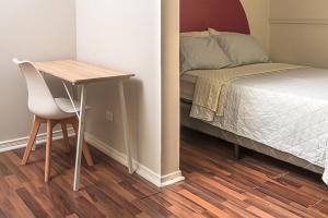 a bedroom with a bed and a desk next to a bed at Hotel Otoya 1907 Downtown in San José