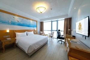 a hotel room with a bed and a flat screen tv at ROYAL J HOTEL in Cebu City