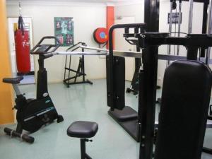 a fitness room with a gym with weights and equipment at Apartment at Cooper St in Sydney