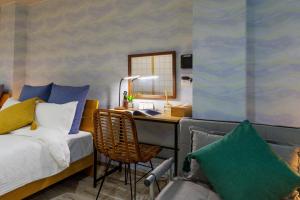 a bedroom with a bed and a desk with a mirror at Southerlies Condominium Onna in Onna +42 photos
