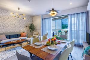 a dining room and living room with a table and chairs at Southerlies Condominium Onna in Onna
