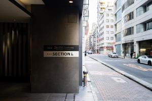a sign on the side of a building on a street at Section L Residence Ginza in Tokyo