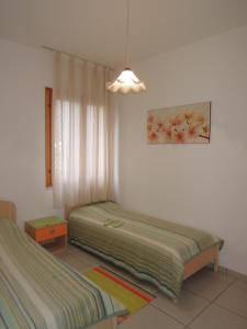 A bed or beds in a room at Villa with garden close to Bibione beach - Beahost