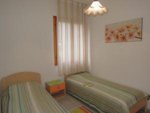 A bed or beds in a room at Villa with garden close to Bibione beach - Beahost