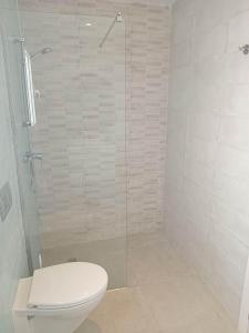 a bathroom with a toilet and a glass shower at Marsa BiBi in Tunis