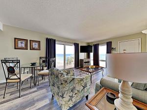 a living room with a couch and a table at Aqua Villa #401 in Fort Walton Beach
