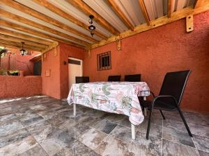 einen Tisch und Stühle in einem Zimmer mit orangefarbenen Wänden in der Unterkunft 4 bedrooms house with enclosed garden and wifi at Ingenio in Ingenio