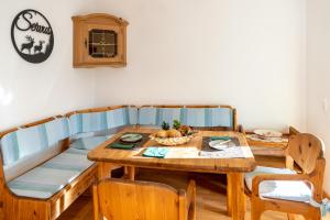 a dining room with a wooden table and a bench at Breitenberg in Bad Hindelang
