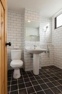 a bathroom with a toilet and a sink at Mini Voyage Hostel in Hualien City
