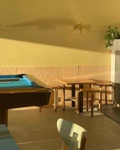 a room with a pool table and two tables at Balestrand Hotel in Balestrand